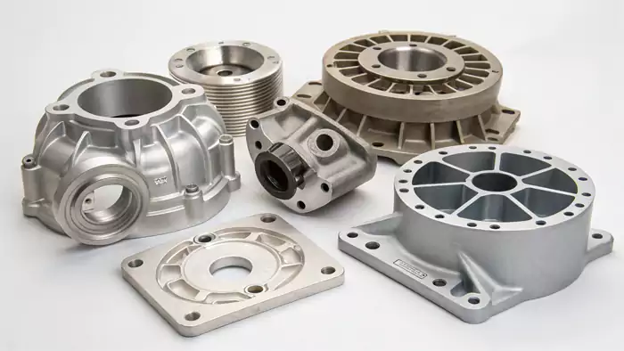 A selection of different die cast metal parts showing various complexities and finishes