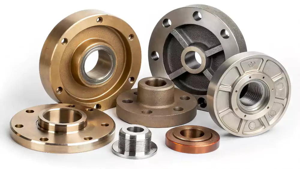 An array of centrifugally cast parts made from different metals: steel, stainless steel, and bronze