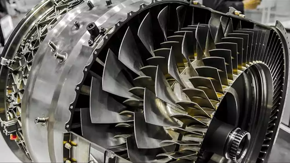 A jet engine cutaway showing rows of intricate turbine blades