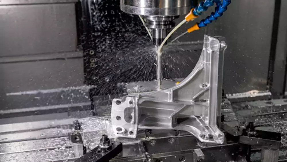 cast engine mount bracket being prepared for precision CNC machining